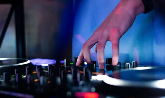 a dj mixing music in a dark room